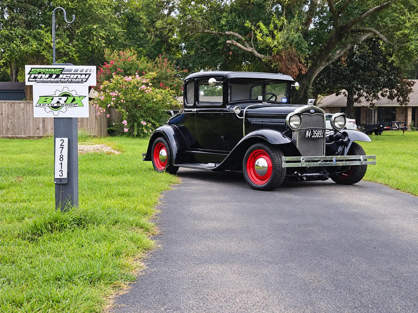 Classic black car beside the Brix Auto sign on Calvert Rd, Tomball, TX