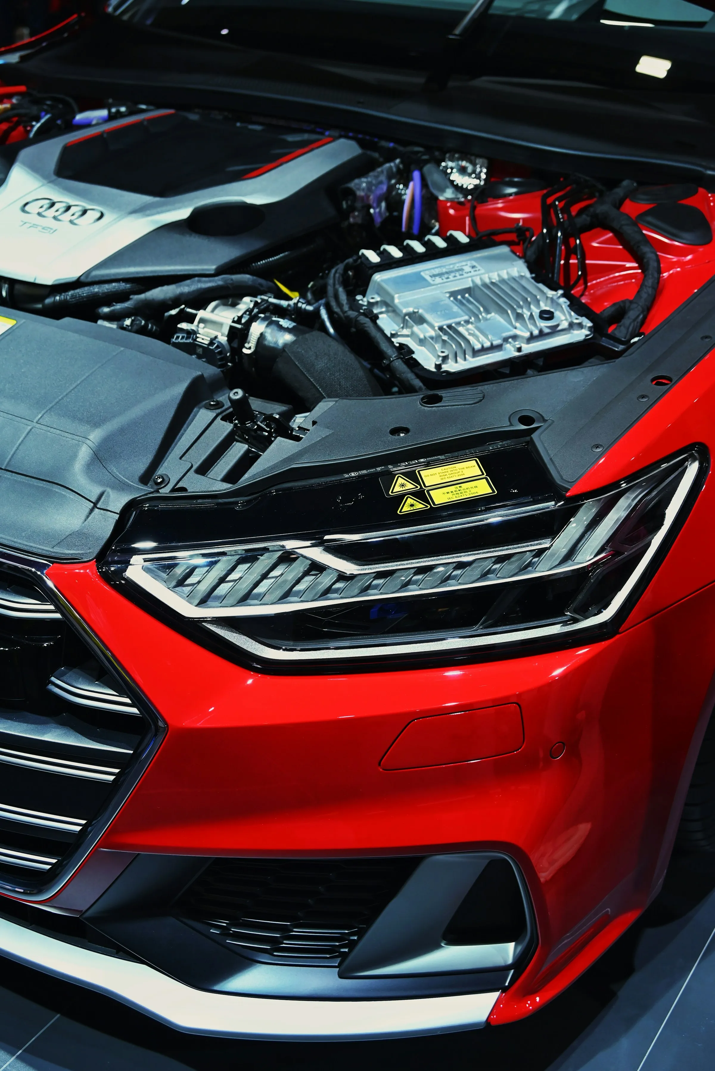 Engine bay and headlight of a red car